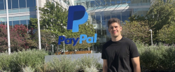 Ivan Olivas pictured with PayPal logo sculpture